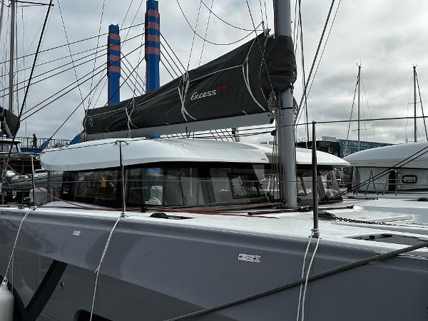 2024 Excess 11 catamaran docked at marina, showcasing sleek design and modern features.