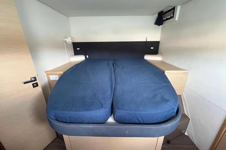 Cozy cabin bed in 2017 Fountaine Pajot SABA 50 yacht, featuring blue bedding.