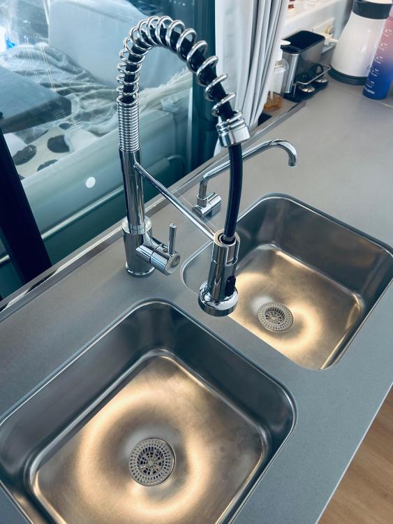 Modern kitchen sink with dual basins and a flexible faucet, in a 2024 Excess 14 model.