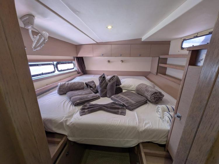 Luxurious cabin interior of 2012 Catana 55 yacht with neatly arranged towels.