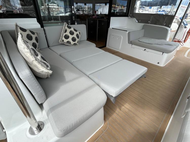 Luxurious 2024 Excess 14 yacht interior with comfortable seating and stylish decor.